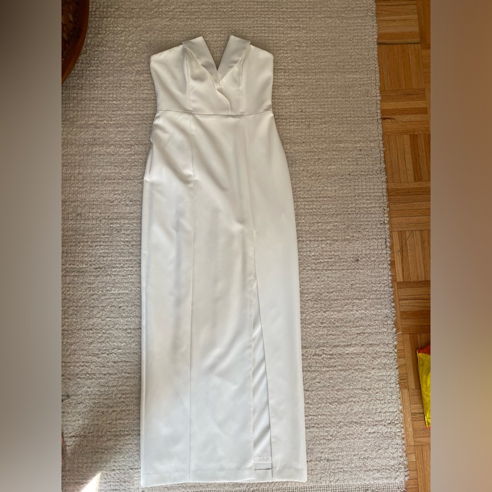 White dress with slit. Strapless. Wore once at wedding afterparty. Dry cleaned